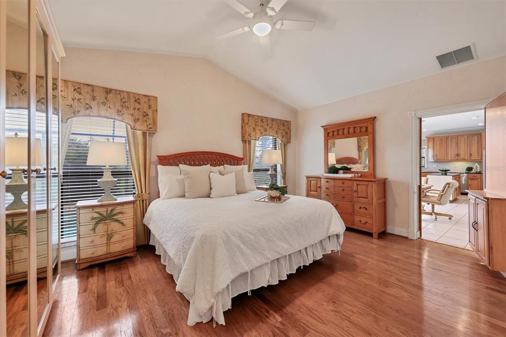133 Inlets Boulevard, Unit 133 Nokomis, FL 34275 - Photo 19 of 63 a bedroom with a bed and wooden floor