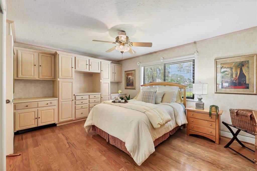 133 Inlets Boulevard, Unit 133 Nokomis, FL 34275 - Photo 24 of 63 a spacious bedroom with a bed and a chandelier