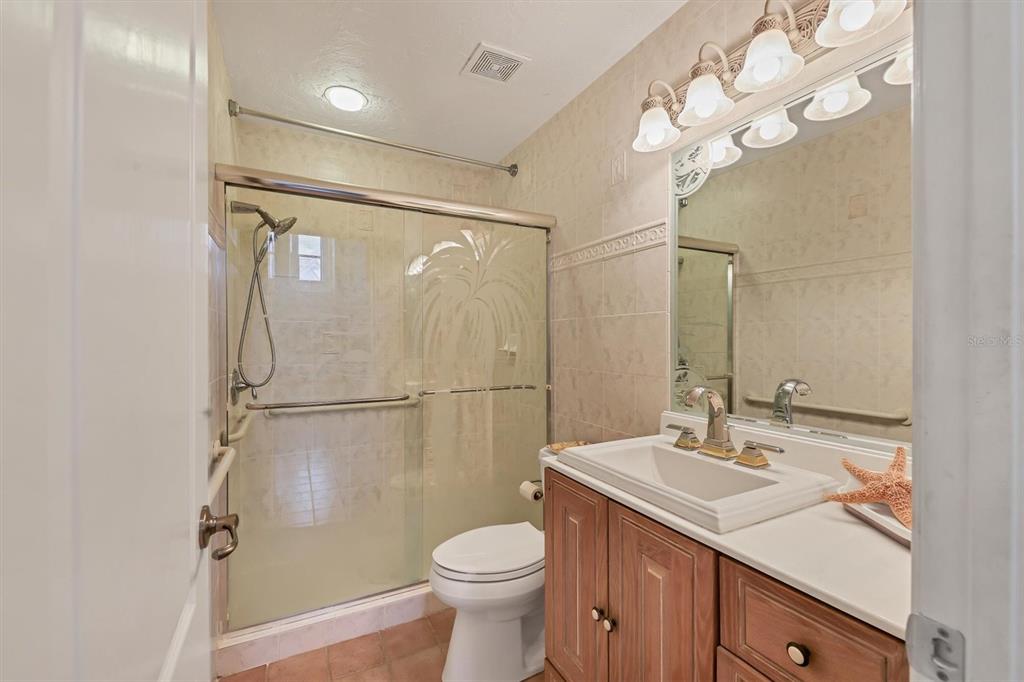 133 Inlets Boulevard, Unit 133 Nokomis, FL 34275 - Photo 25 of 63 a bathroom with a sink toilet and shower