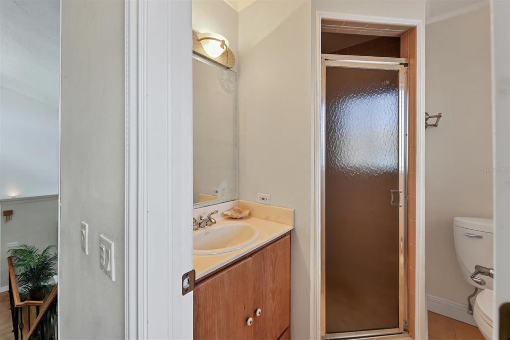 133 Inlets Boulevard, Unit 133 Nokomis, FL 34275 - Photo 28 of 63 a bathroom with a sink and mirror