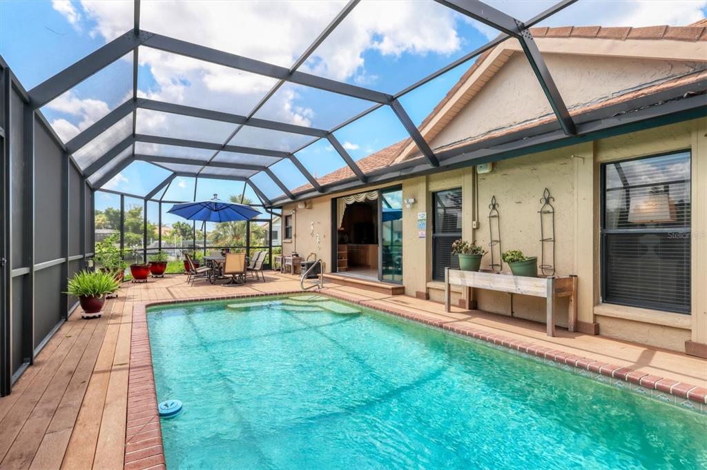 133 Inlets Boulevard, Unit 133 Nokomis, FL 34275 - Photo 31 of 63 a view of a backyard with a patio and fire pit