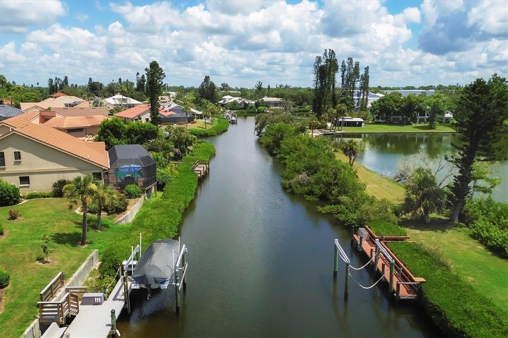 133 Inlets Boulevard, Unit 133 Nokomis, FL 34275 - Photo 38 of 63 a view of a lake with a yard