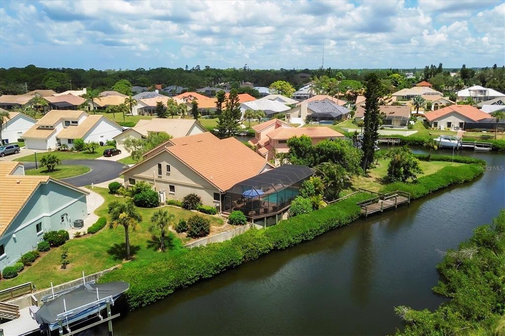 133 Inlets Boulevard, Unit 133 Nokomis, FL 34275 - Photo 39 of 63 an aerial view of residential houses with outdoor space and lake view