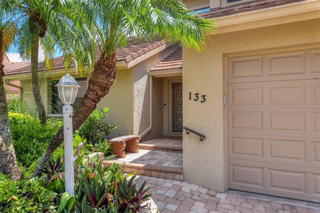 133 Inlets Boulevard, Unit 133 Nokomis, FL 34275 - Photo 5 of 63 a front view of a house with a garden