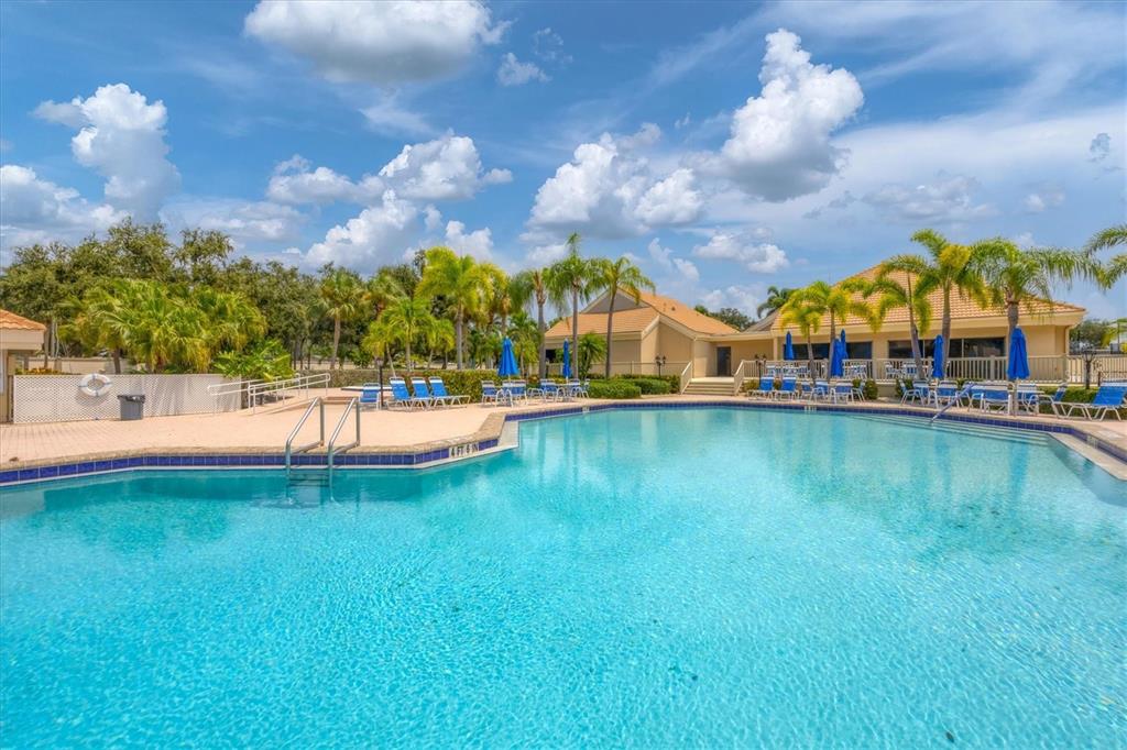 133 Inlets Boulevard, Unit 133 Nokomis, FL 34275 - Photo 52 of 63 a view of a swimming pool with an outdoor space and seating