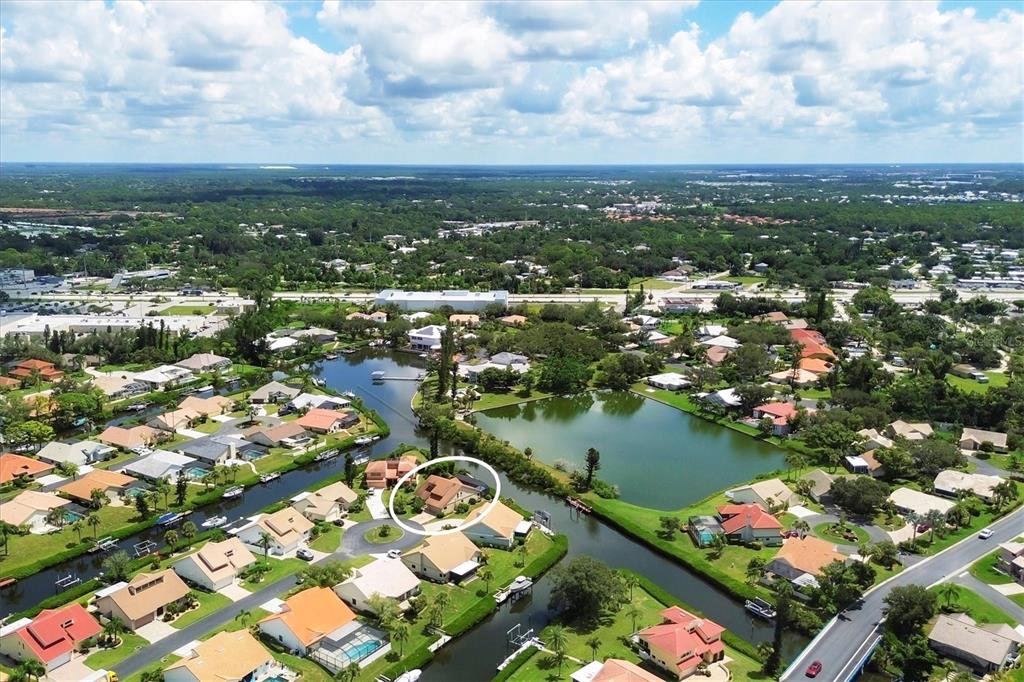 133 Inlets Boulevard, Unit 133 Nokomis, FL 34275 - Photo 62 of 63 an aerial view of city and lake