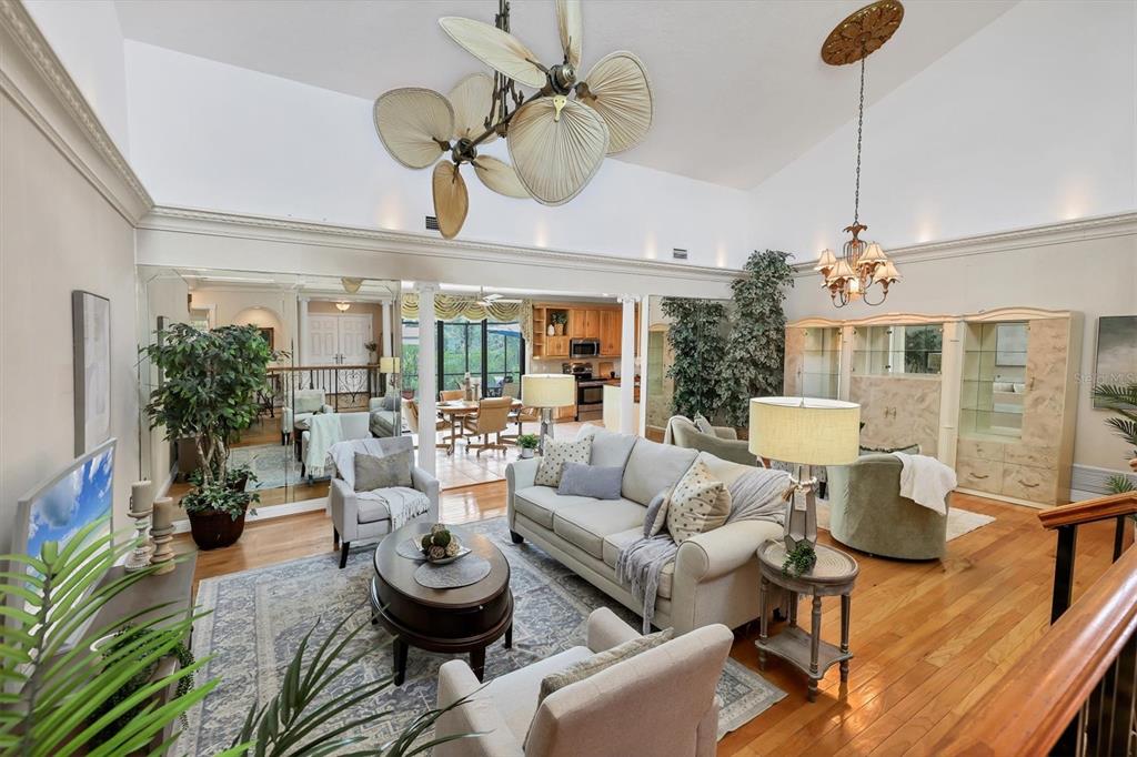 133 Inlets Boulevard, Unit 133 Nokomis, FL 34275 - Photo 7 of 63 a living room with furniture a chandelier and a dining room