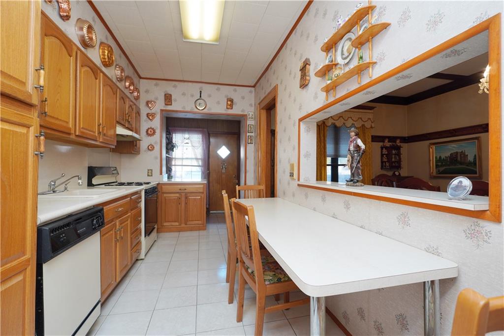 649 Bay Ridge Parkway Brooklyn, NY 11209 - Photo 12 of 29 a kitchen with stainless steel appliances granite countertop a sink and cabinets