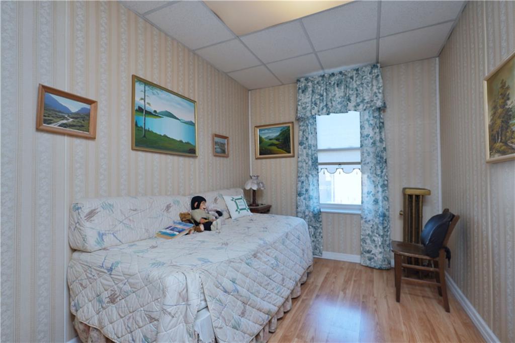 649 Bay Ridge Parkway Brooklyn, NY 11209 - Photo 19 of 29 a bed room with a bed and a chair