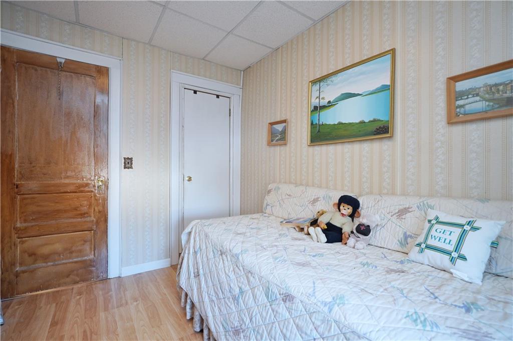 649 Bay Ridge Parkway Brooklyn, NY 11209 - Photo 20 of 29 a bedroom with a bed and a wooden floor