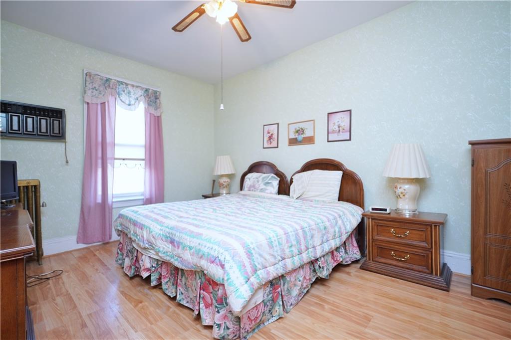 649 Bay Ridge Parkway Brooklyn, NY 11209 - Photo 23 of 29 a bedroom with a bed and a dresser with wooden floor