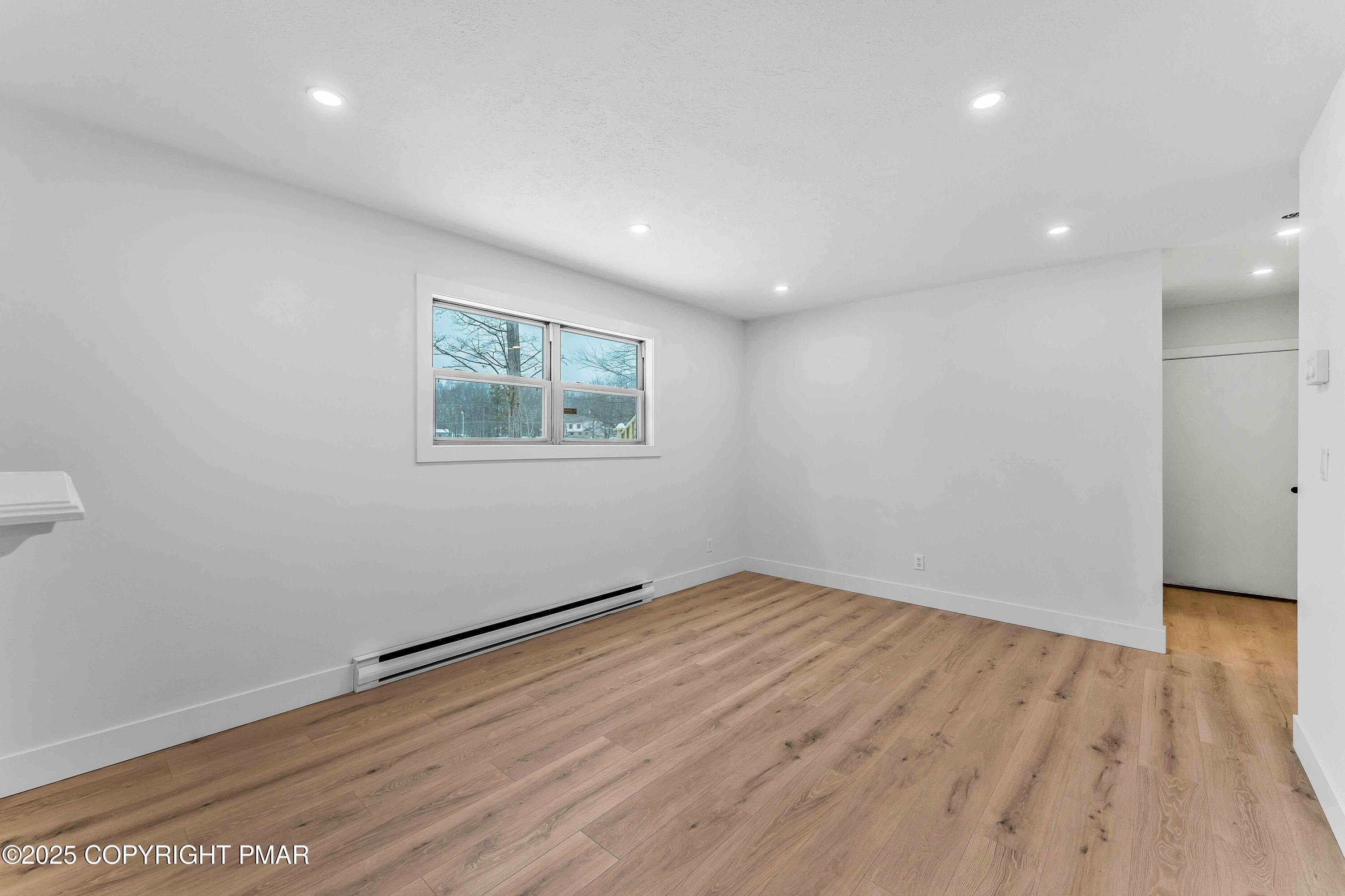 2127 Bushkill Circle Bushkill, PA 18324 - Photo 35 of 47 an empty room with wooden floor and windows