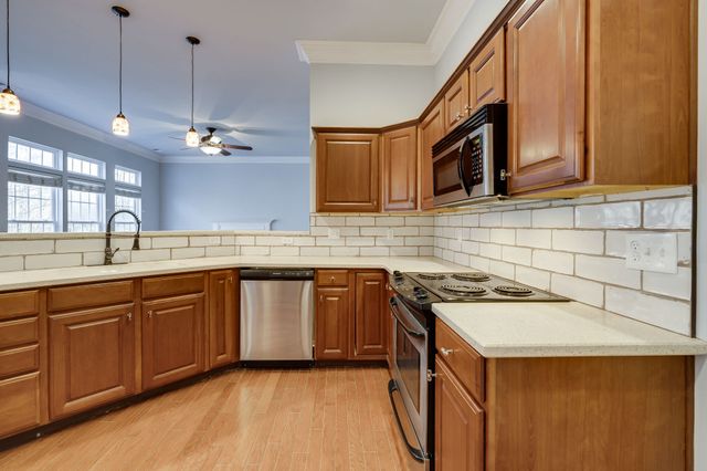 a kitchen with a sink stove and cabinets