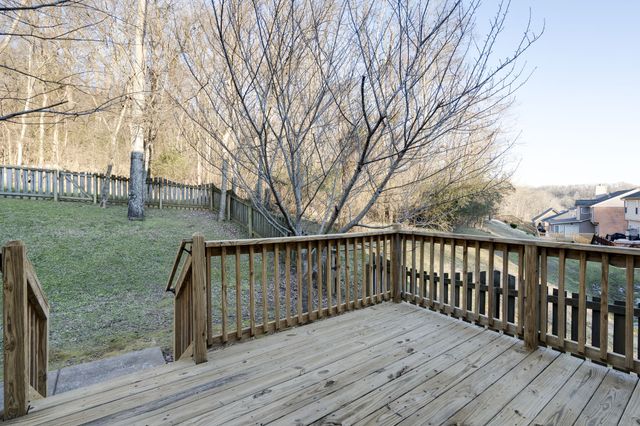 a balcony with wooden floor and fence