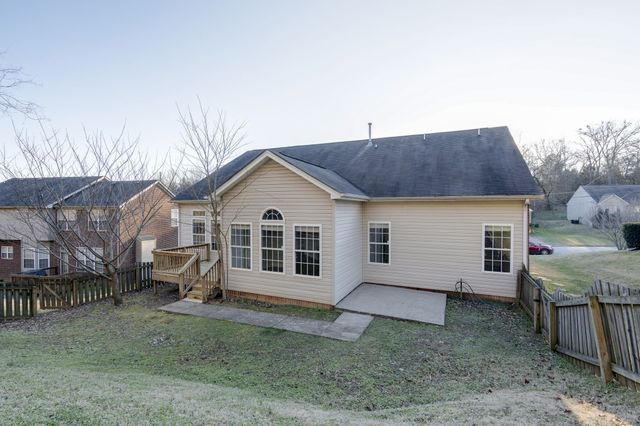 a view of a house with a yard and garage