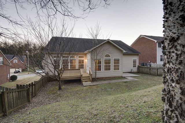 a view of a house with a yard and garage