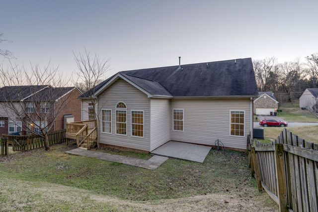 a view of a house with a yard and sitting area