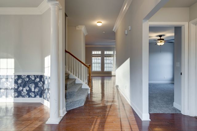a view of entryway and hall with wooden floor