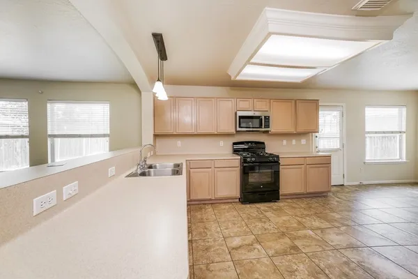 a kitchen with a sink cabinets and window