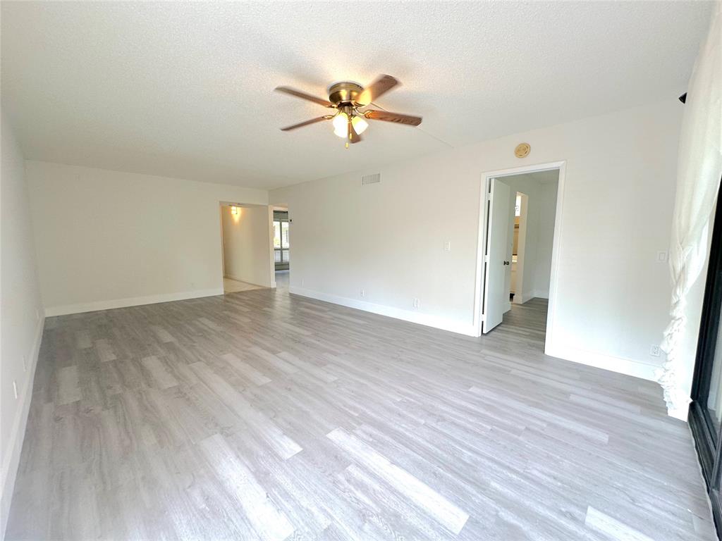 159 Northwest 70th Street, Unit 517 Boca Raton, FL 33487 - Photo 11 of 30 a view of empty room with wooden floor