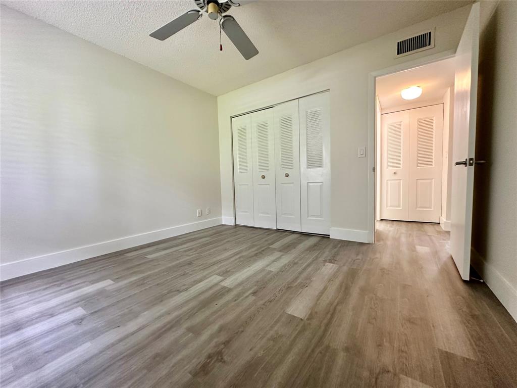 159 Northwest 70th Street, Unit 517 Boca Raton, FL 33487 - Photo 24 of 30 wooden floor in an empty room with a window