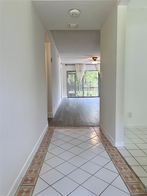 159 Northwest 70th Street, Unit 517 Boca Raton, FL 33487 - Photo 5 of 30 a view of a hallway with a window