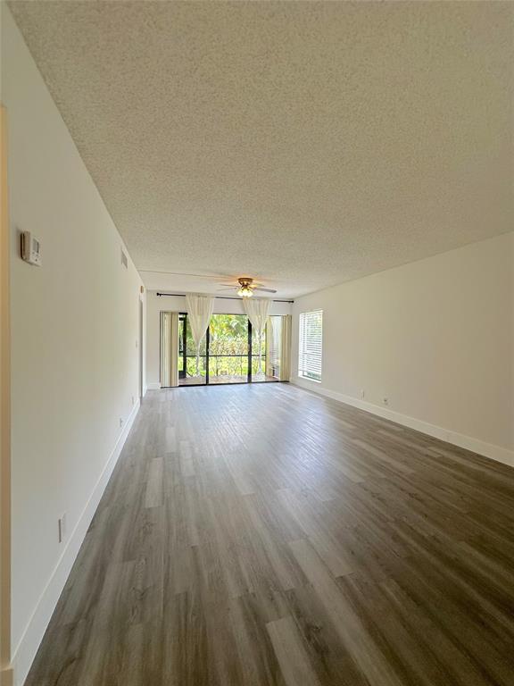 159 Northwest 70th Street, Unit 517 Boca Raton, FL 33487 - Photo 6 of 30 wooden floor in an empty room with a window