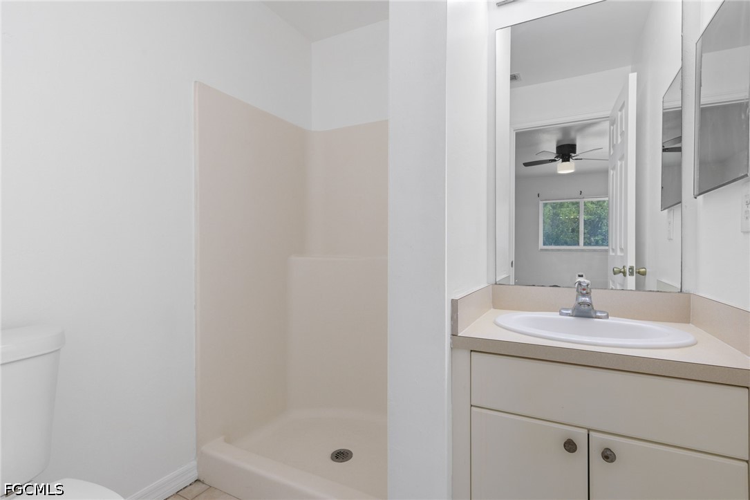 221 Meadow Road Lehigh Acres, FL 33973 - Photo 8 of 13 a bathroom with a sink and a mirror
