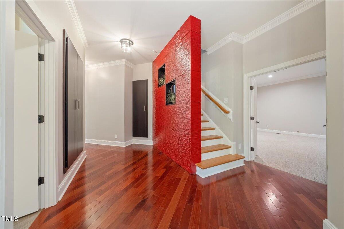 6300 Swallow Cove Lane Raleigh, NC 27614 - Photo 22 of 67 a view of a hallway with wooden floor and staircase