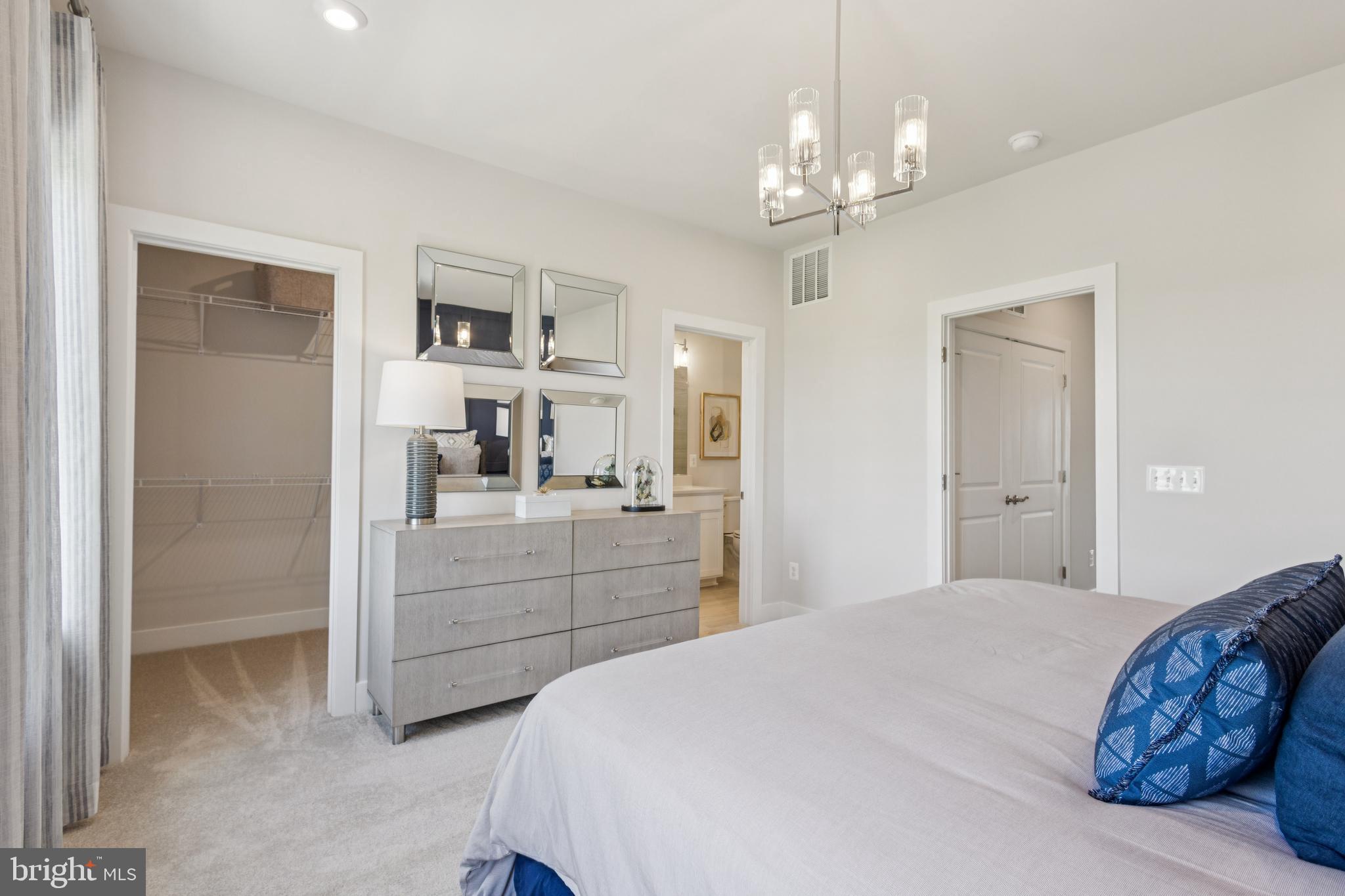 3803 Shale Ridge Road Woodbridge, VA 22193 - Photo 12 of 23 a bedroom with a large bed and a chandelier