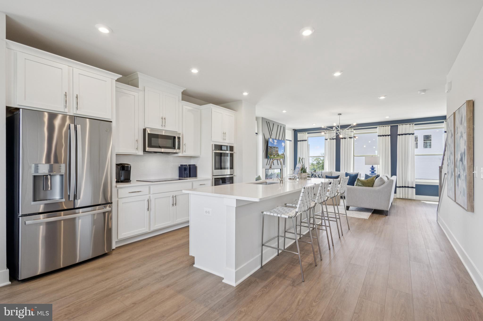 3803 Shale Ridge Road Woodbridge, VA 22193 - Photo 5 of 23 a kitchen with white cabinets and stainless steel appliances