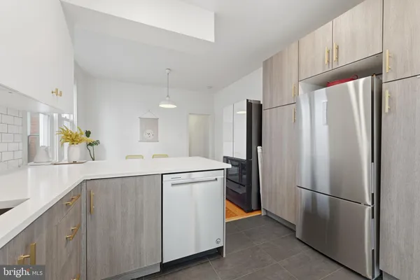 a kitchen with a refrigerator and a sink