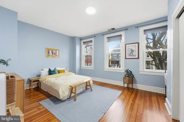 a bedroom with a bed and a large window