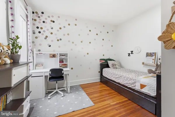 a bedroom with bed and a potted plant