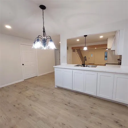 an empty room with chandelier fan