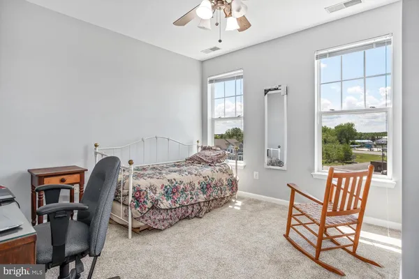 a bed room with a bed and a chair