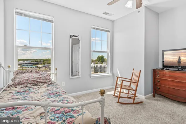 a bedroom with furniture and a flat screen tv