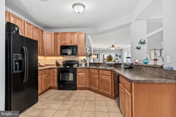 a kitchen with stainless steel appliances granite countertop a refrigerator stove top oven a sink and dishwasher