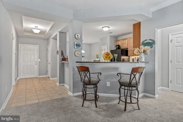a dining room filled with furniture and a chandelier