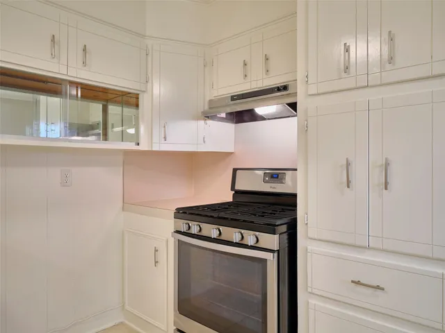 a kitchen with a sink cabinets and appliances