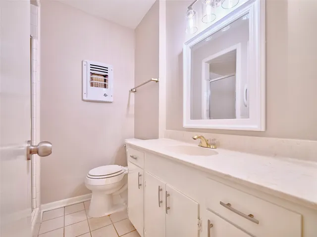 a white toilet sitting next to a bathroom sink