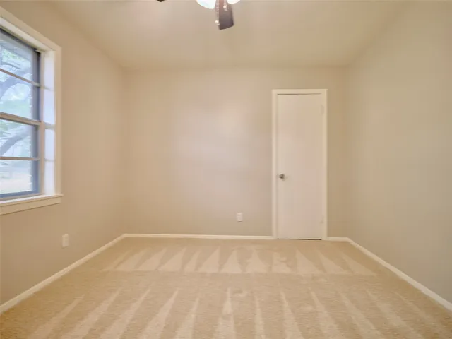 a bathroom with a sink a toilet and a window