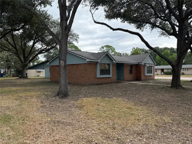 a house that has a tree in front of the house