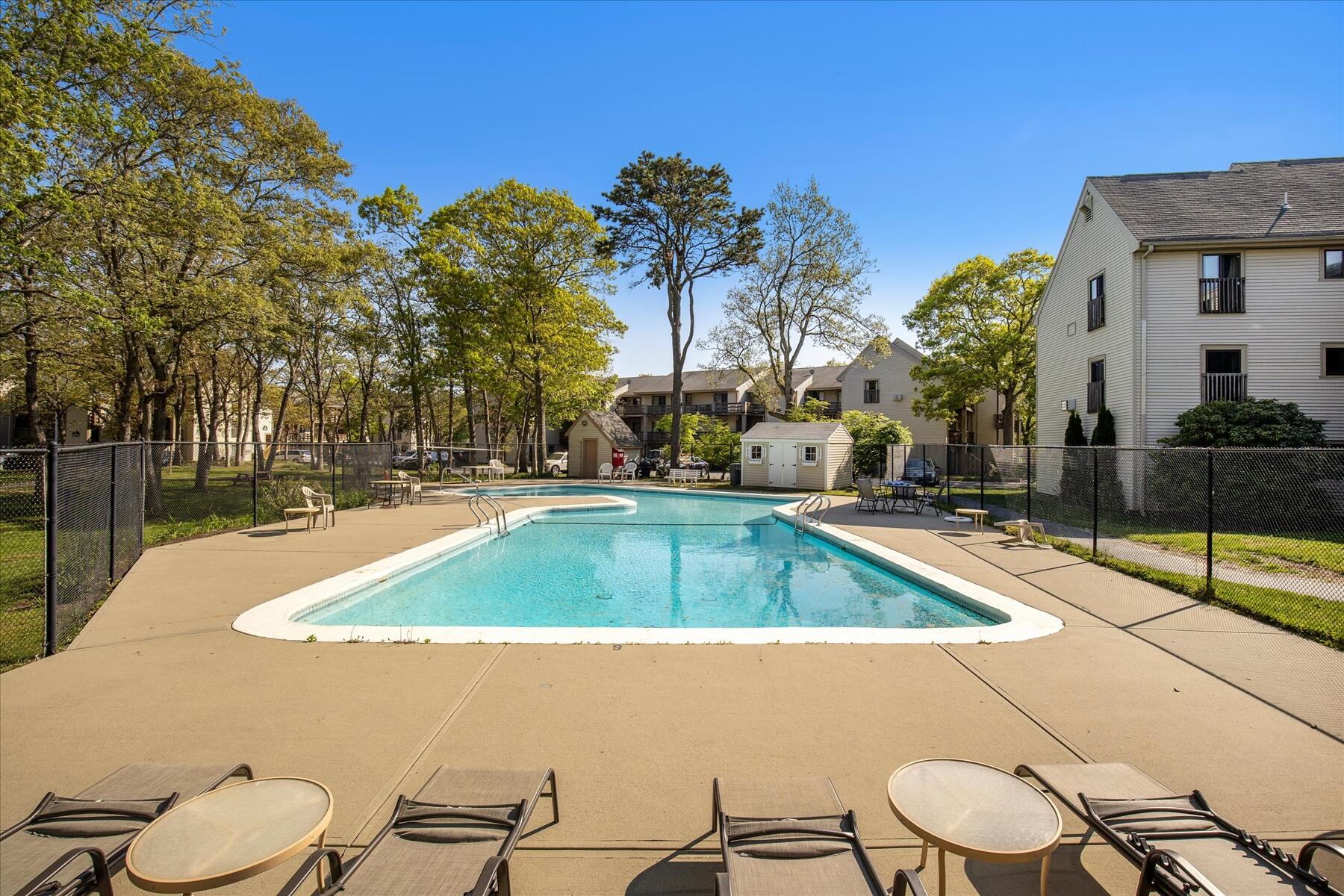 800 Bearses Way, Unit 1EB Hyannis, MA 02601 - Photo 28 of 37 a view of a backyard with swimming pool and sitting area