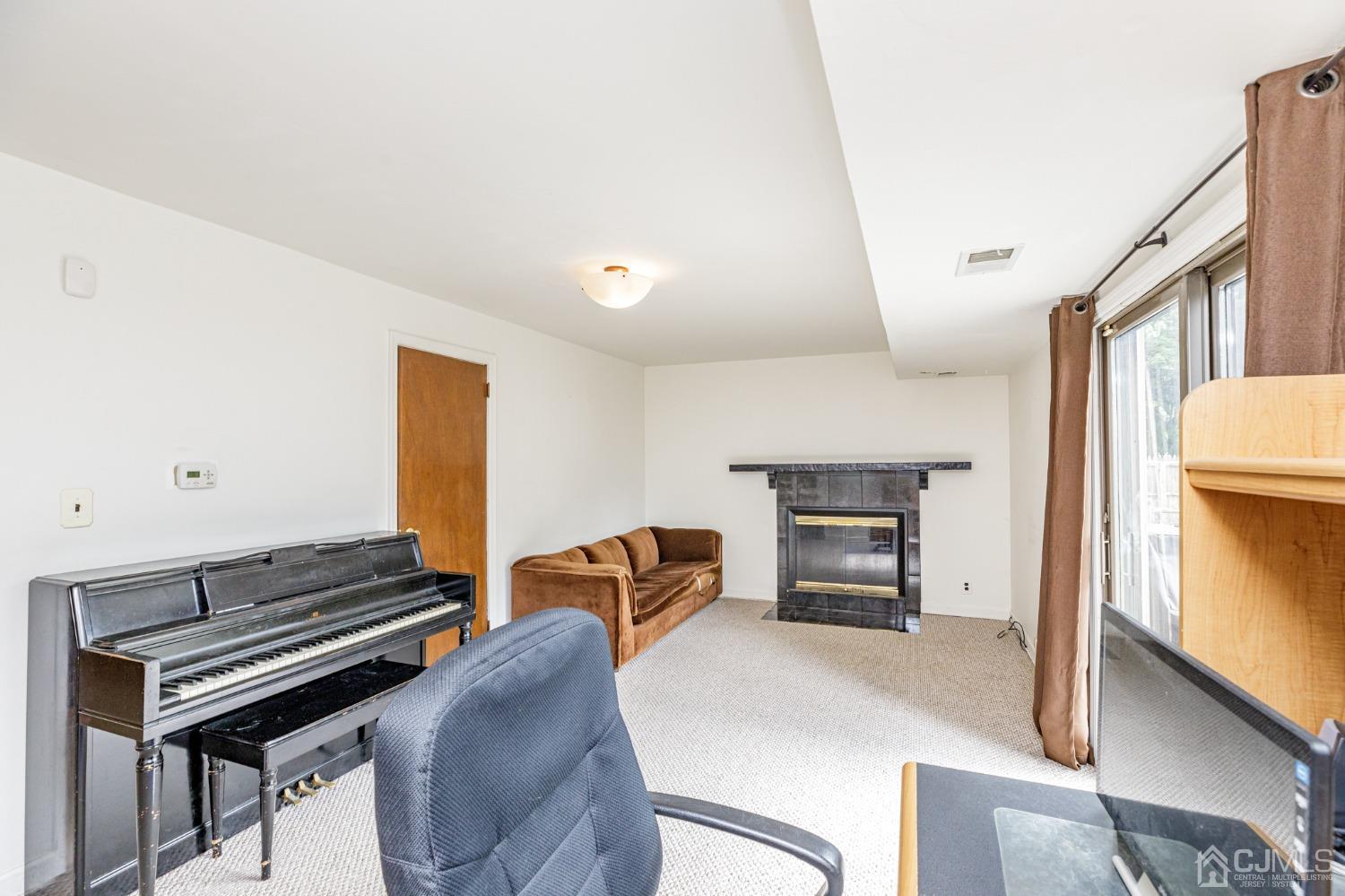 38 Marlin Avenue East Edison, NJ 08820 - Photo 24 of 36 a living room with furniture and a fireplace
