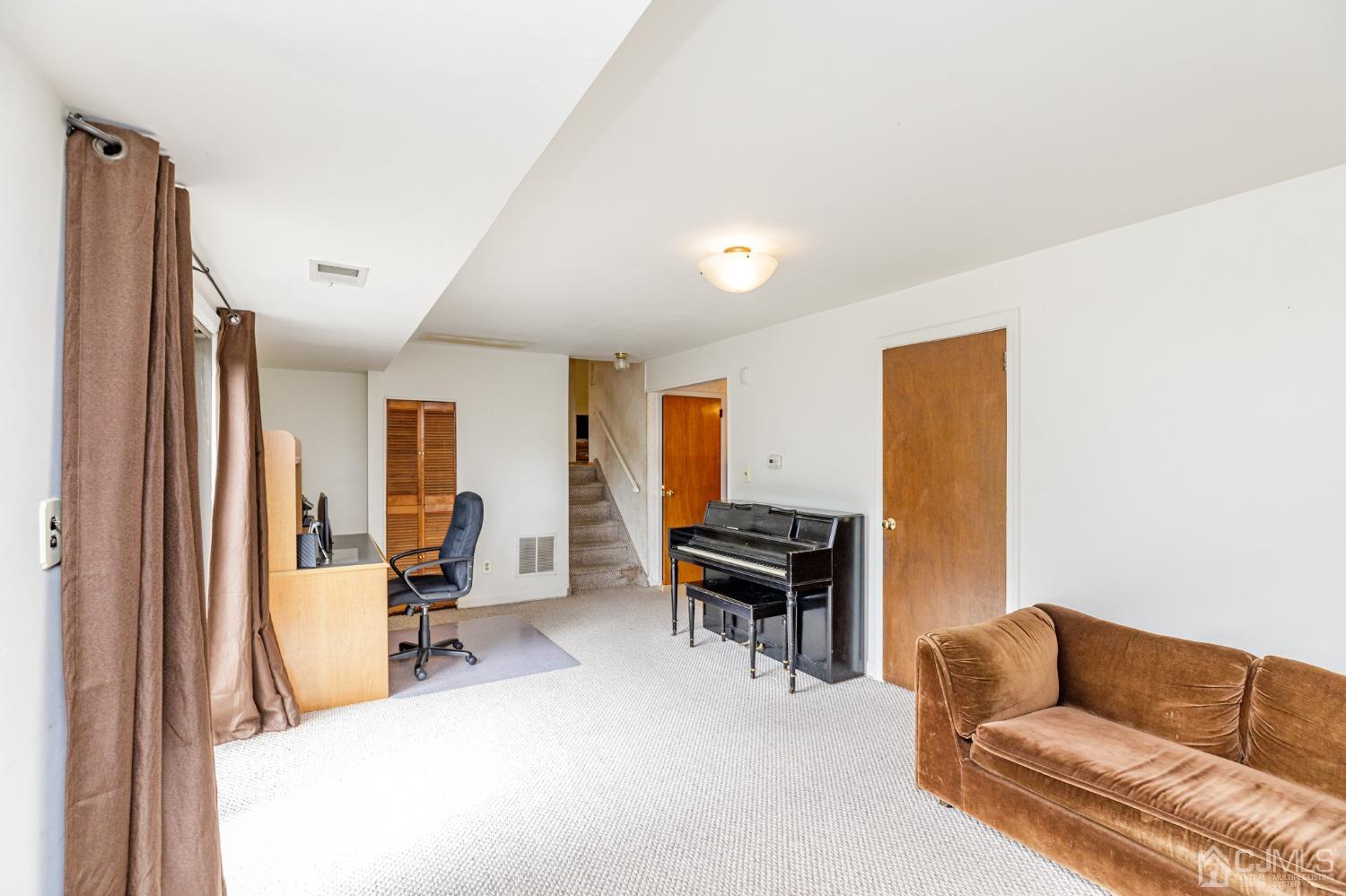 38 Marlin Avenue East Edison, NJ 08820 - Photo 26 of 36 a living room with furniture a piano and a flat screen tv