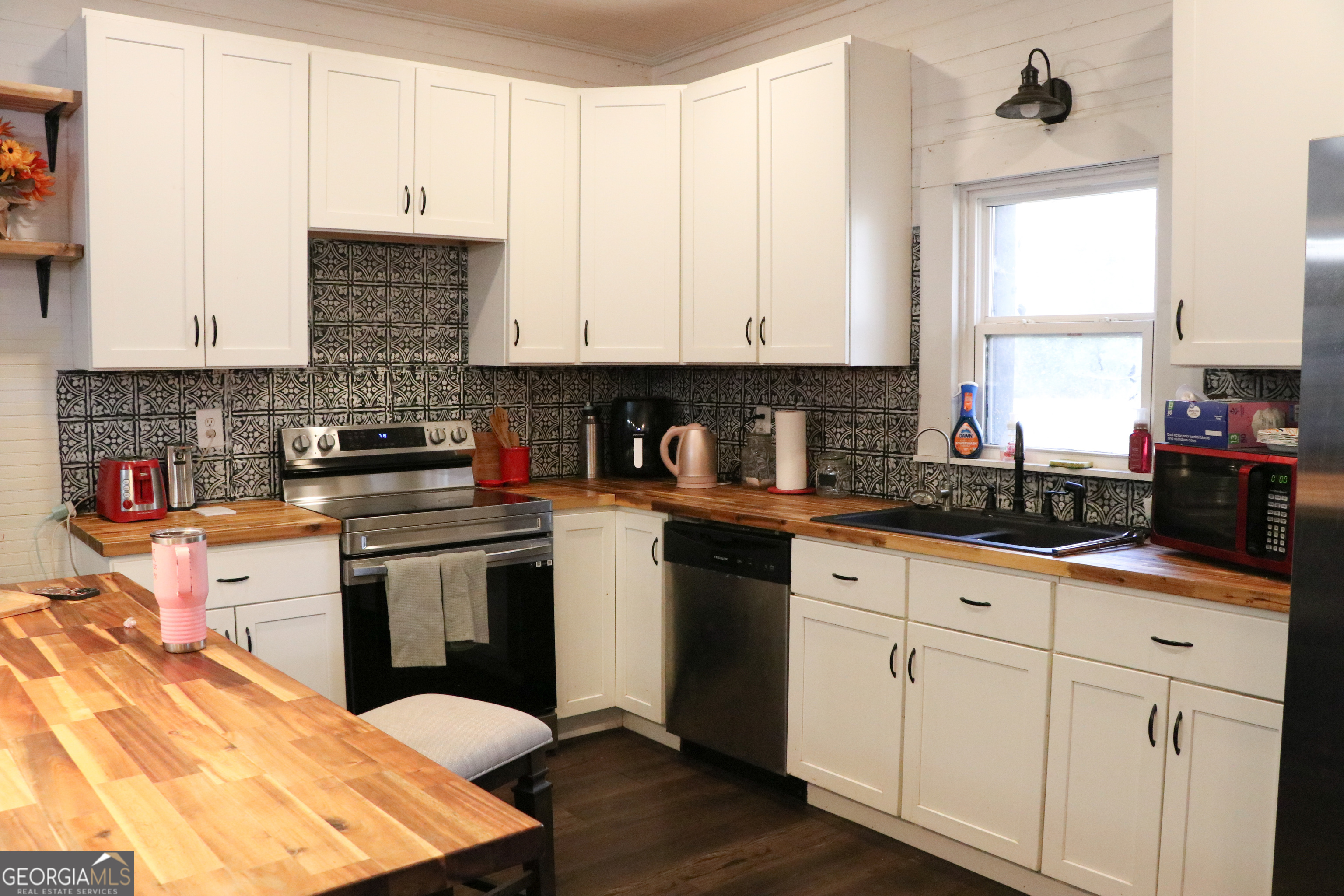 441 Lyerly Dam Road Lyerly, GA 30730 - Photo 35 of 77 a kitchen with stainless steel appliances granite countertop a stove a sink and white cabinets