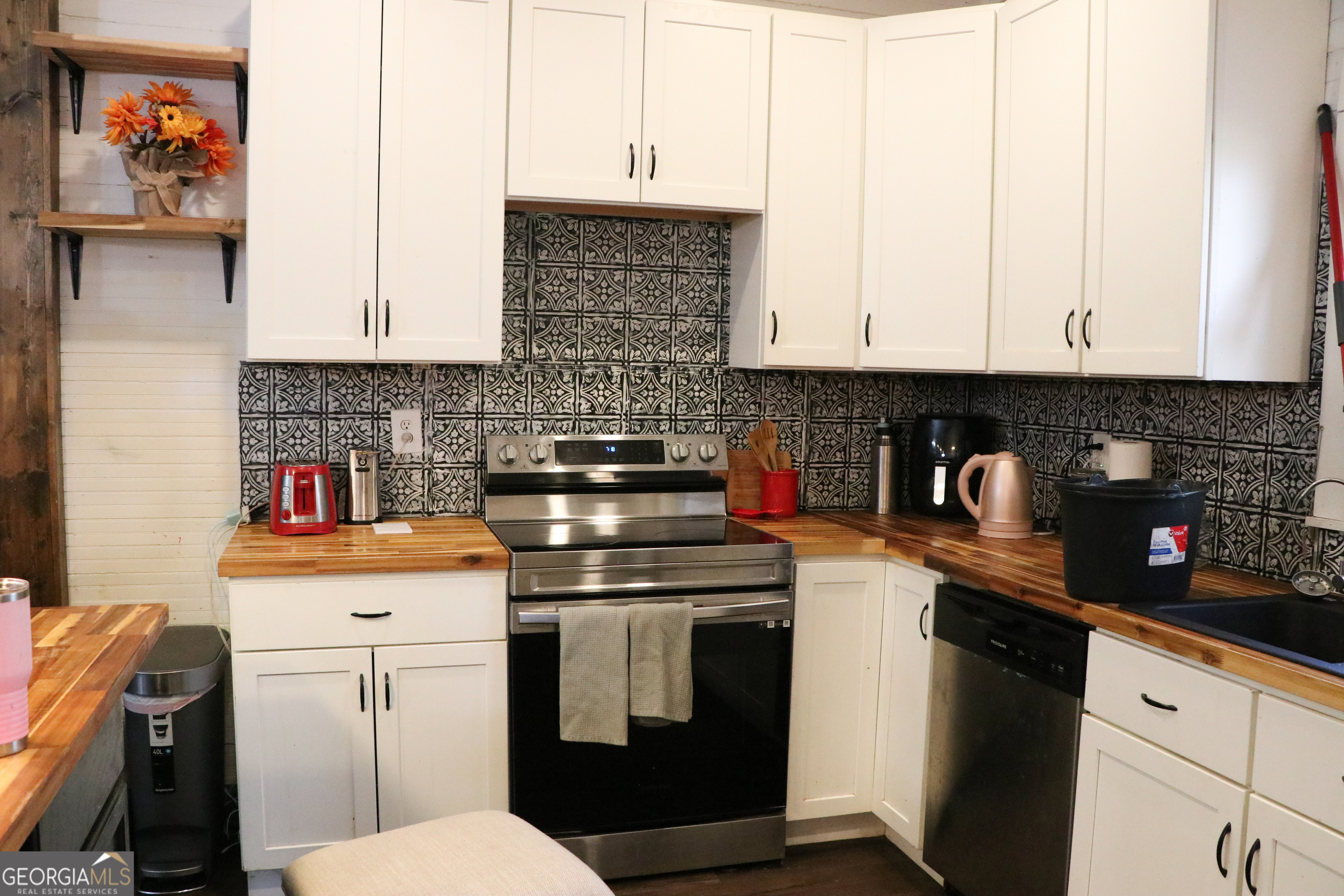 441 Lyerly Dam Road Lyerly, GA 30730 - Photo 36 of 80 a kitchen with stainless steel appliances granite countertop a stove a sink and white cabinets