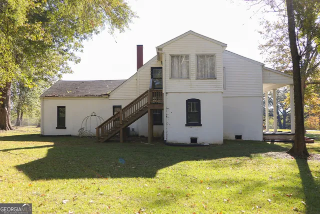 a swimming pool with outdoor seating and yard