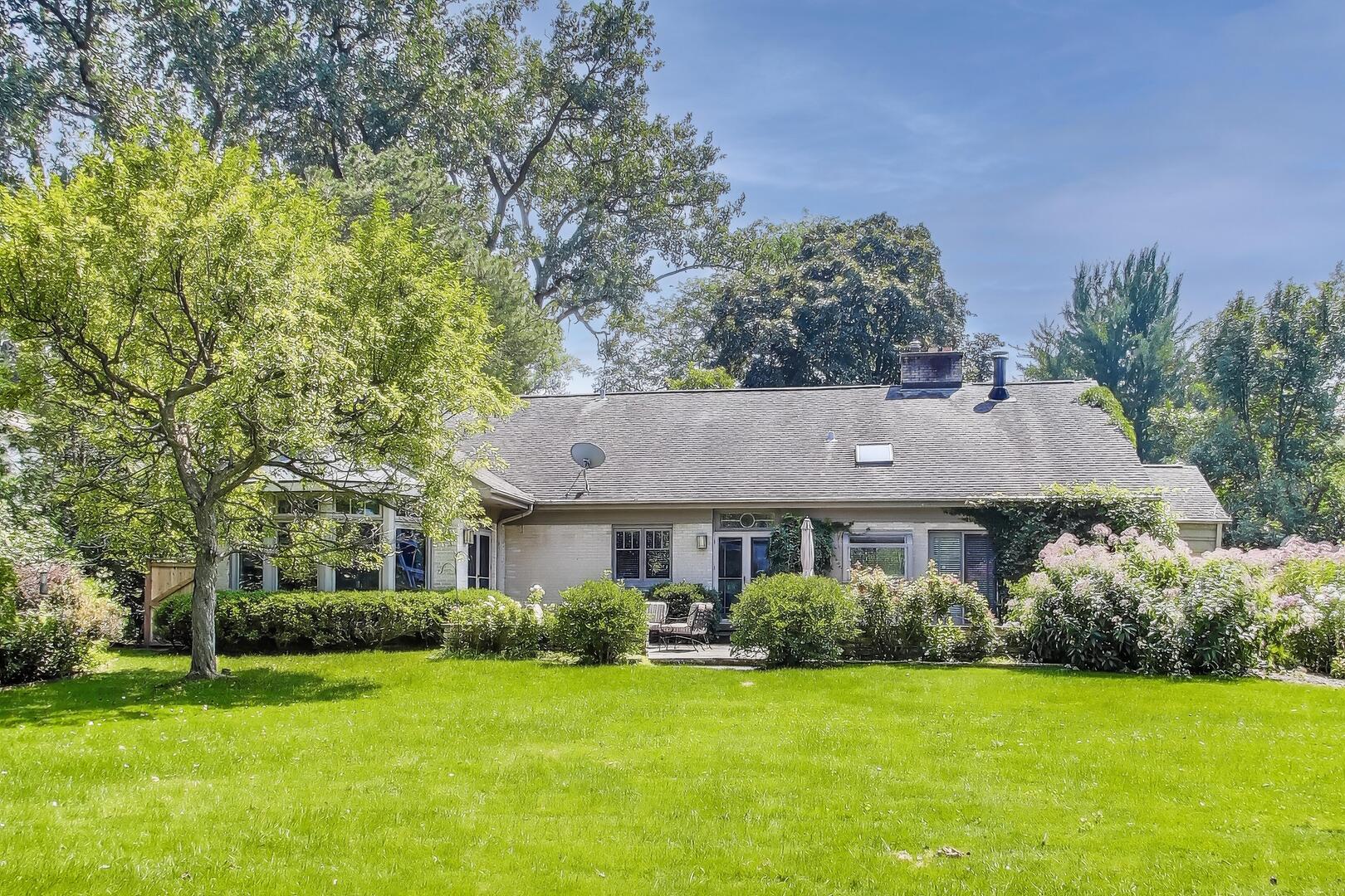 1295 Sunview Lane Winnetka, IL 60093 - Photo 2 of 8 a front view of a house with a yard and trees